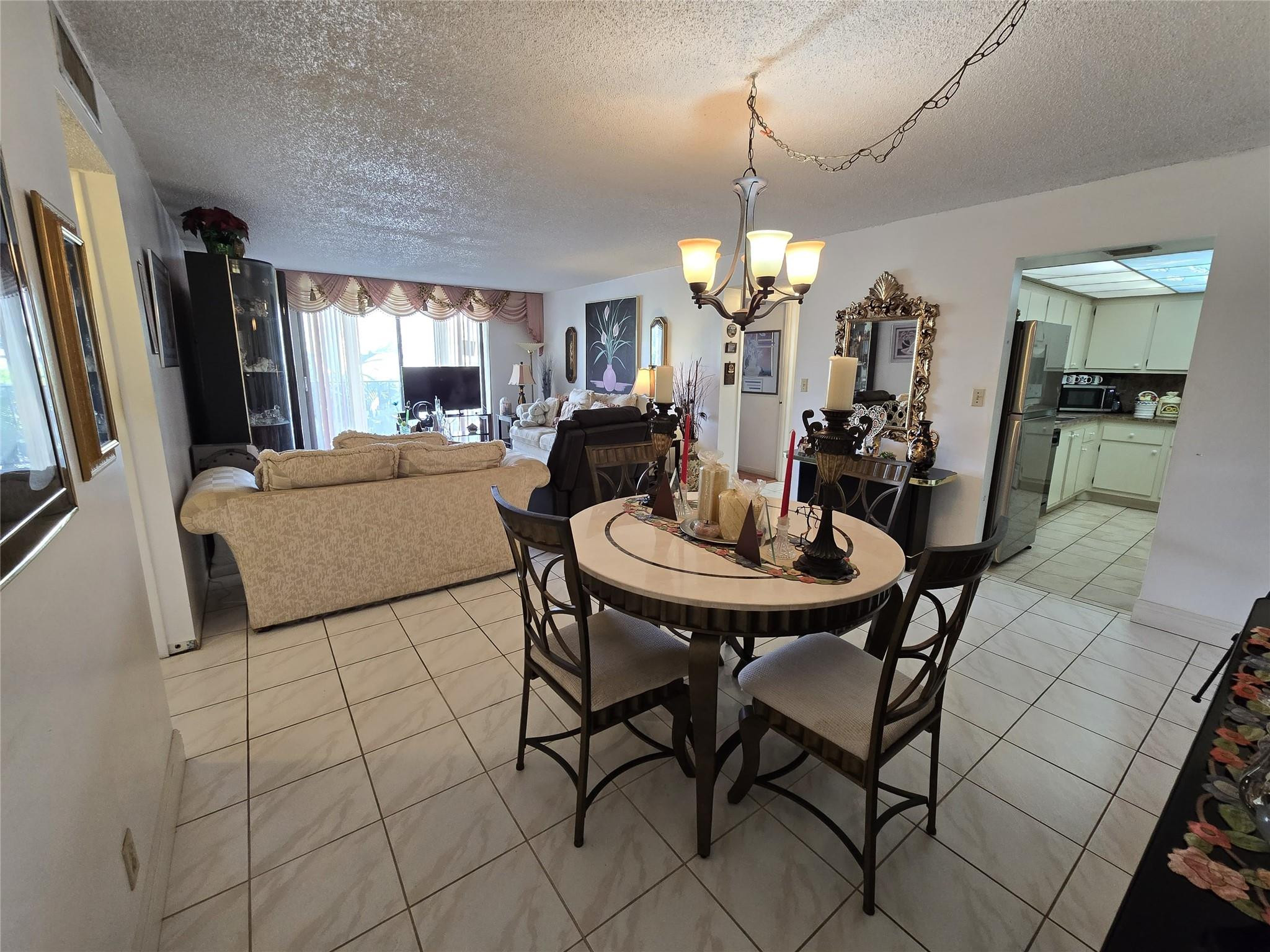 6195 Rock Island Road, Unit 215 Tamarac, FL 33319 - Photo 13 of 37 a view of a dining room with furniture and window