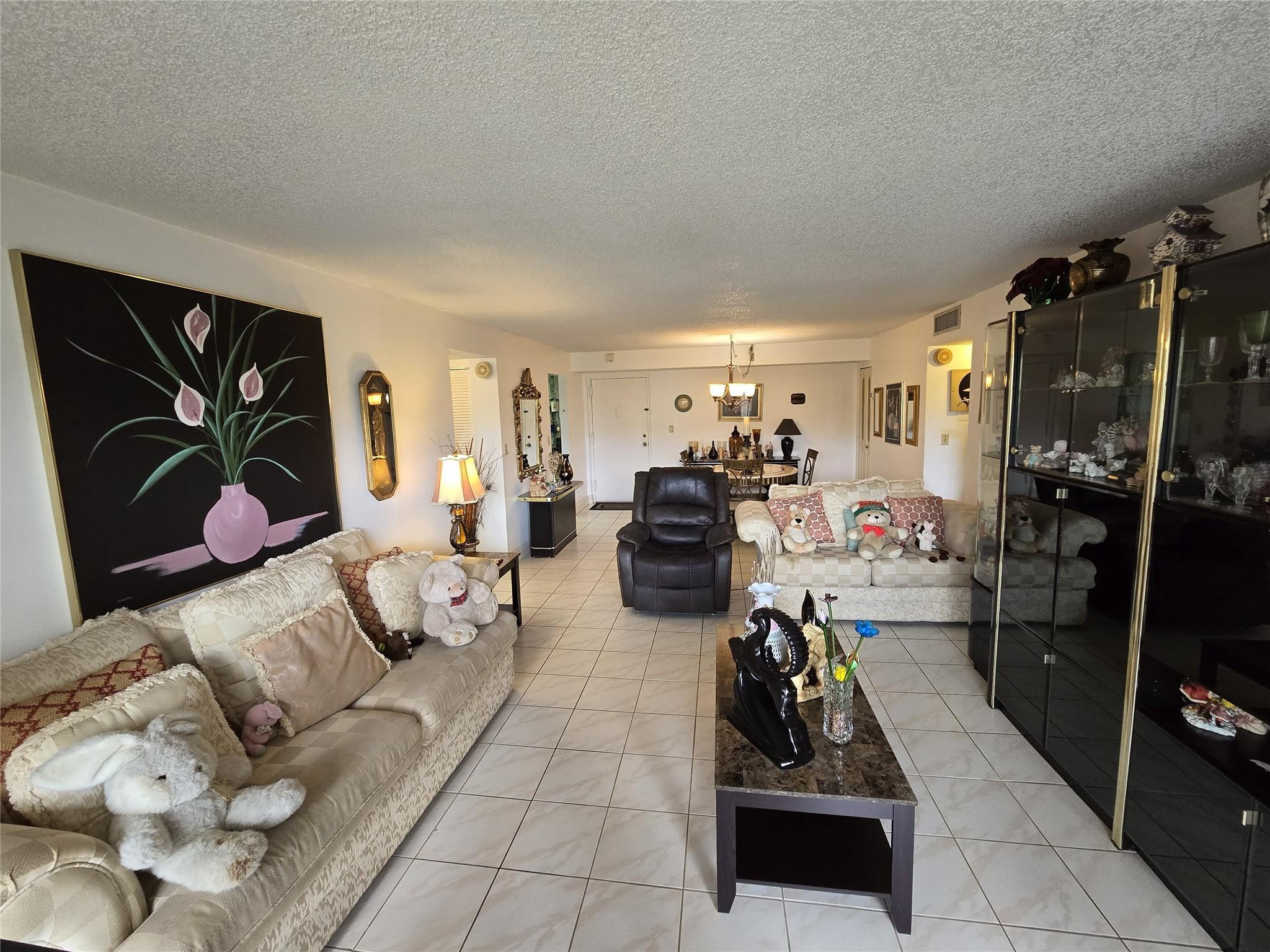 6195 Rock Island Road, Unit 215 Tamarac, FL 33319 - Photo 16 of 37 a room with furniture or couch and a flat screen tv