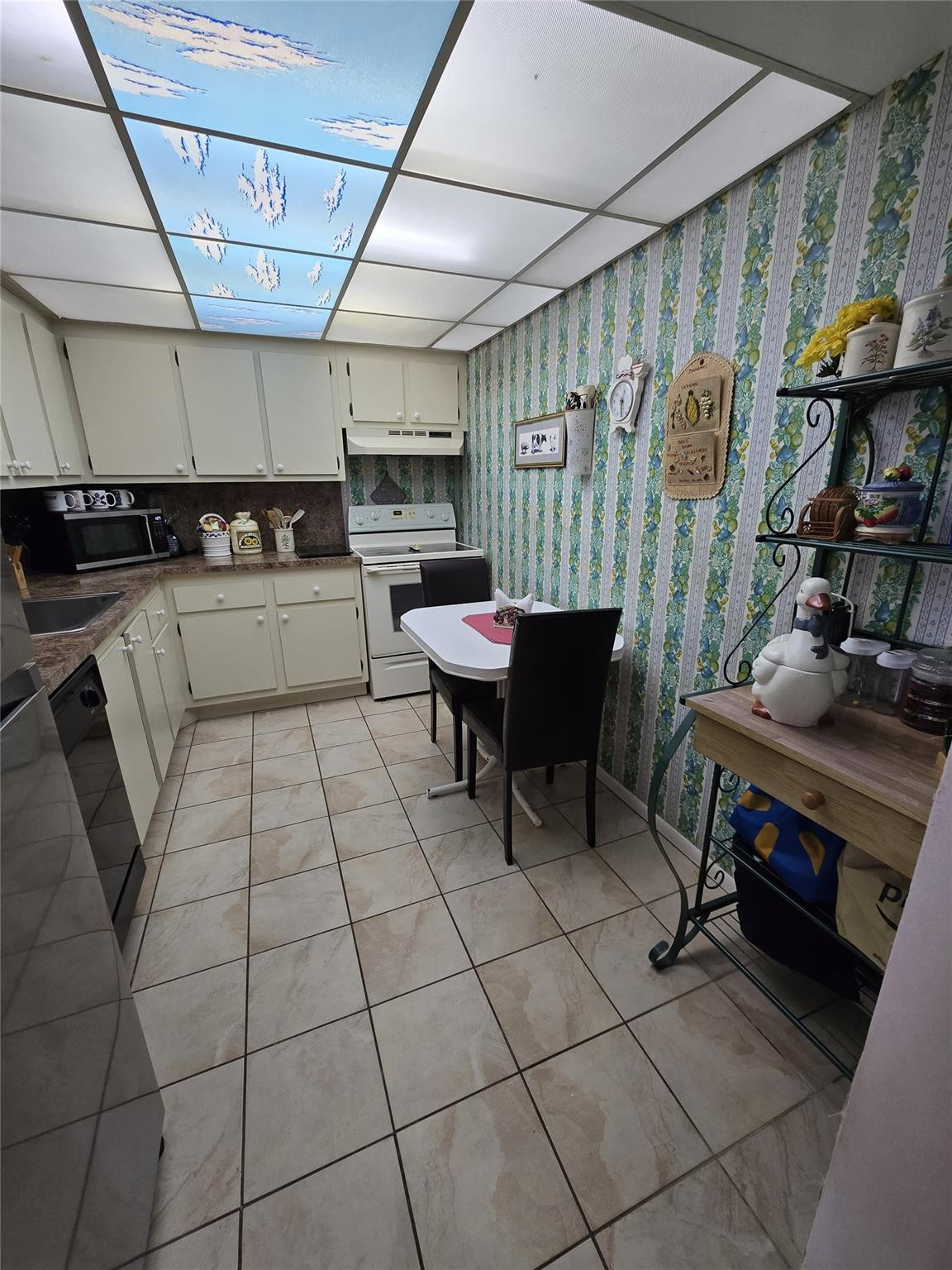 6195 Rock Island Road, Unit 215 Tamarac, FL 33319 - Photo 23 of 37 a kitchen with a sink and cabinets