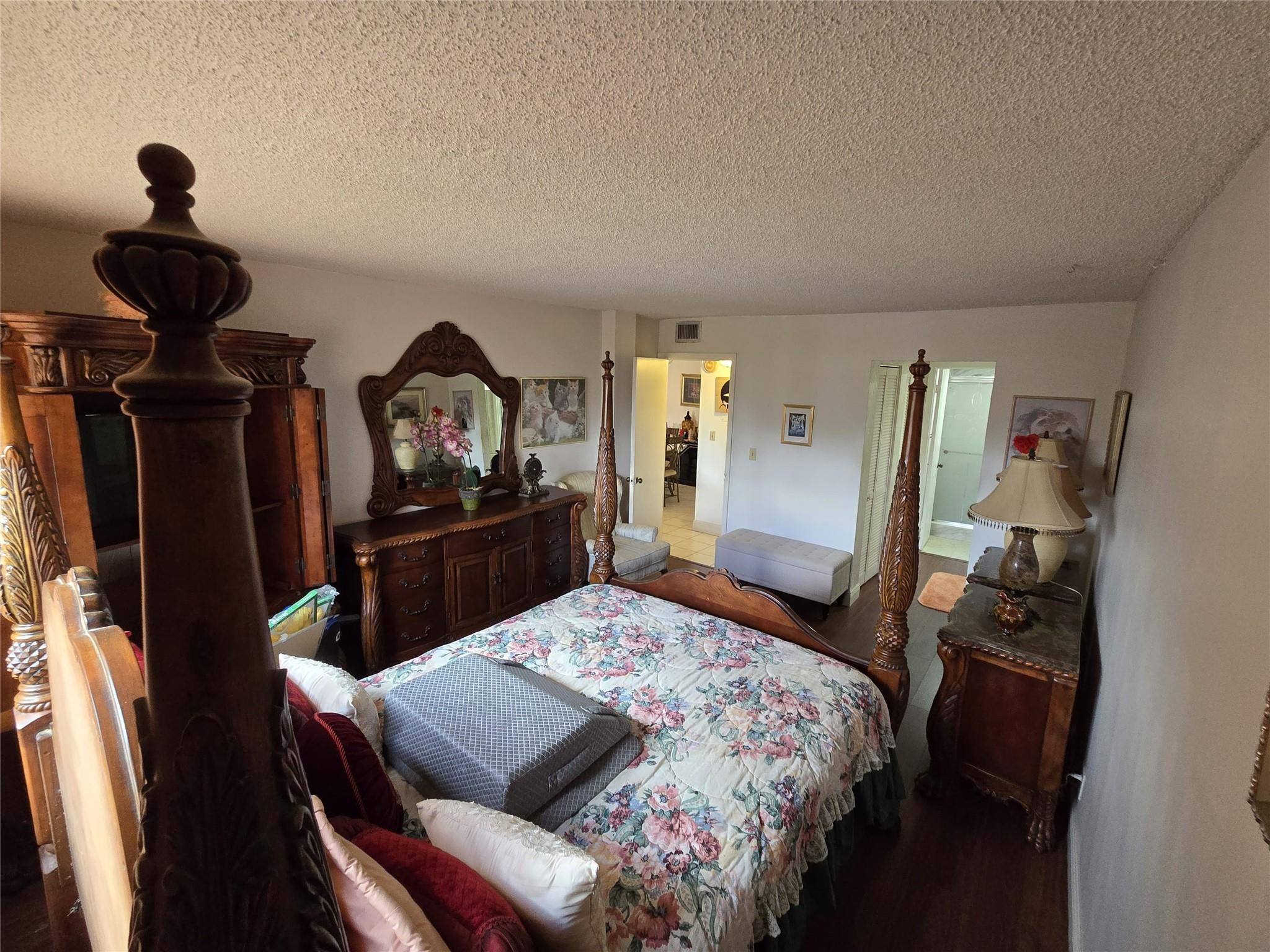 6195 Rock Island Road, Unit 215 Tamarac, FL 33319 - Photo 25 of 37 a bedroom with a bed and a mirror in it