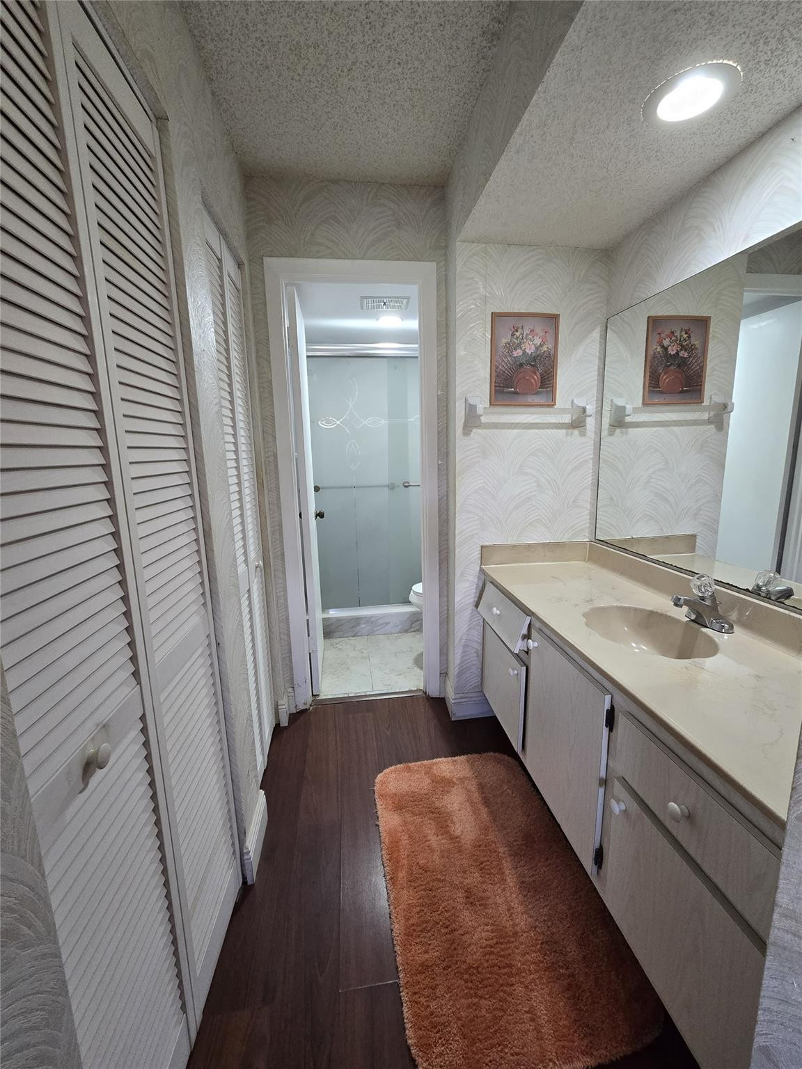 6195 Rock Island Road, Unit 215 Tamarac, FL 33319 - Photo 27 of 37 a bathroom with a sink a mirror and a bathtub