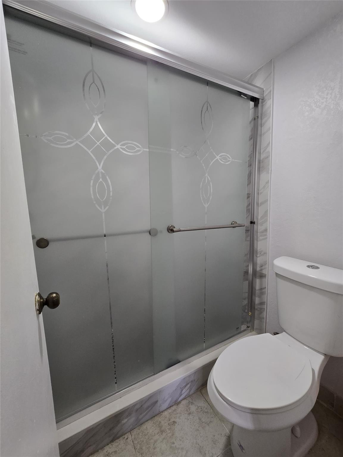 6195 Rock Island Road, Unit 215 Tamarac, FL 33319 - Photo 30 of 37 a bathroom with a toilet and a shower