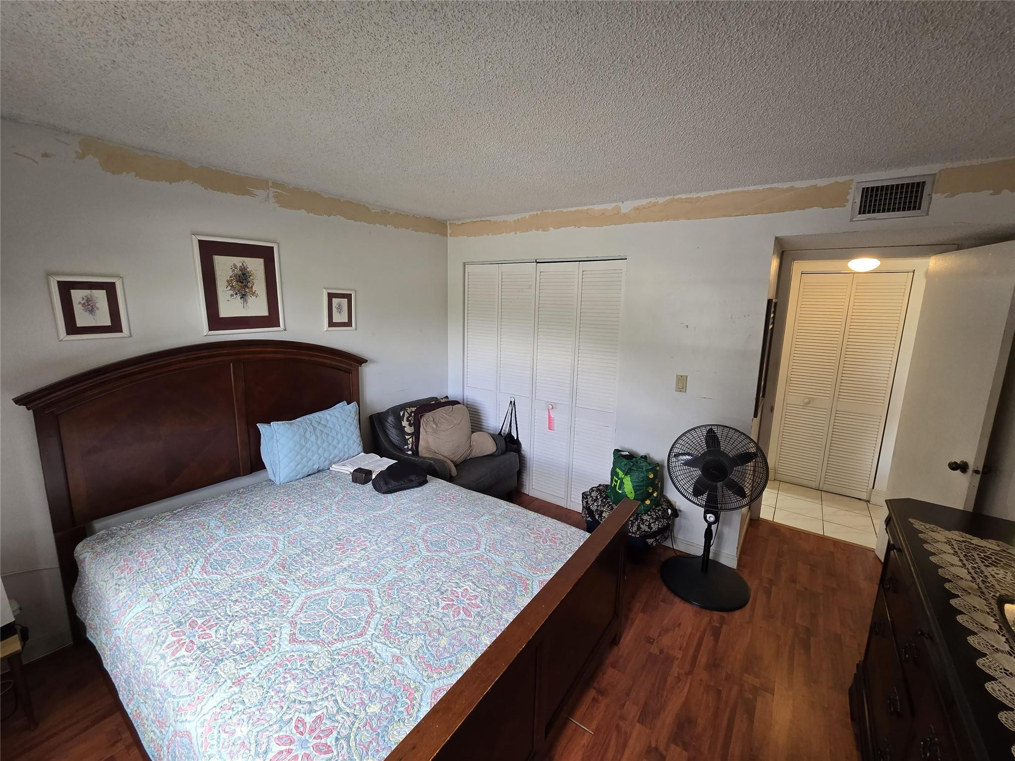6195 Rock Island Road, Unit 215 Tamarac, FL 33319 - Photo 31 of 37 a bedroom with a bed and a dresser