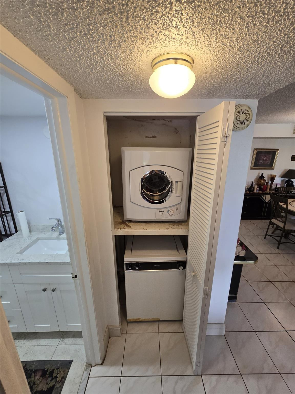 6195 Rock Island Road, Unit 215 Tamarac, FL 33319 - Photo 35 of 37 a utility room with dryer and washer