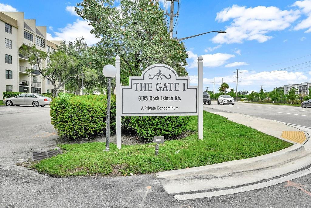 6195 Rock Island Road, Unit 215 Tamarac, FL 33319 - Photo 8 of 37 a view of a park that has a sign board