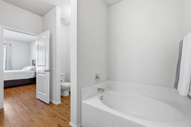 a bathroom with a tub shower and a sink