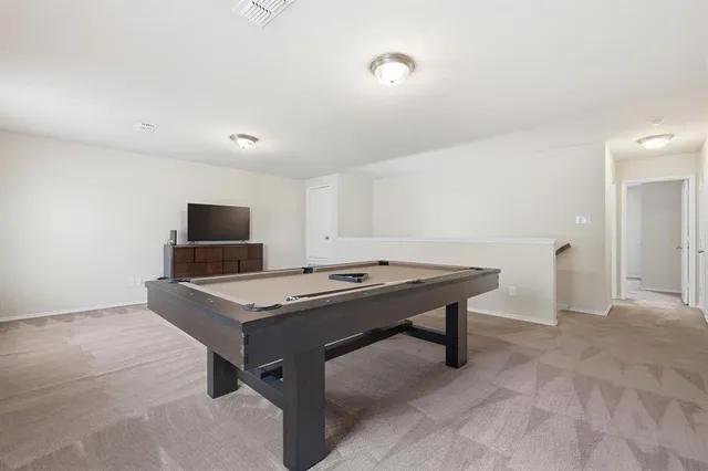 a room with furniture pool table and flat screen tv