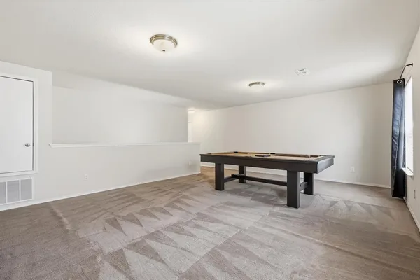 a view of an empty room with a bench