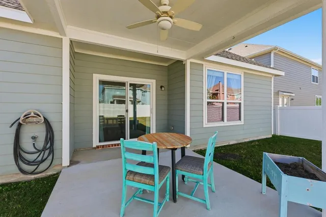 a view of a patio with table and chairs with a barbeque grill
