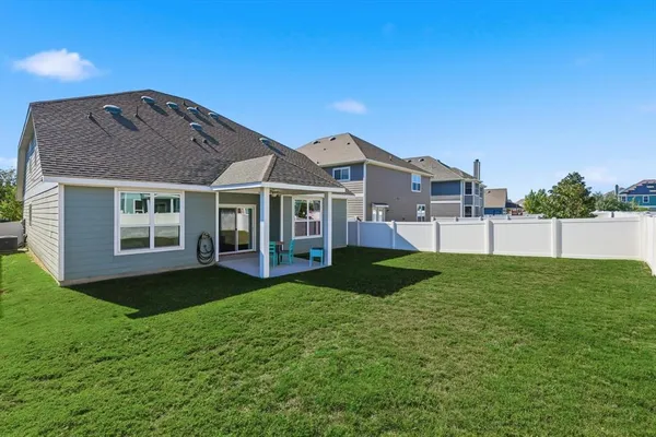 a view of a yard in front of a house with large garden