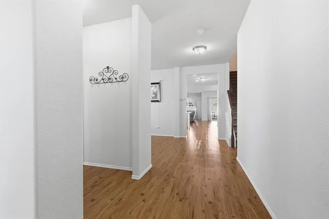 a view of a hallway with wooden floor