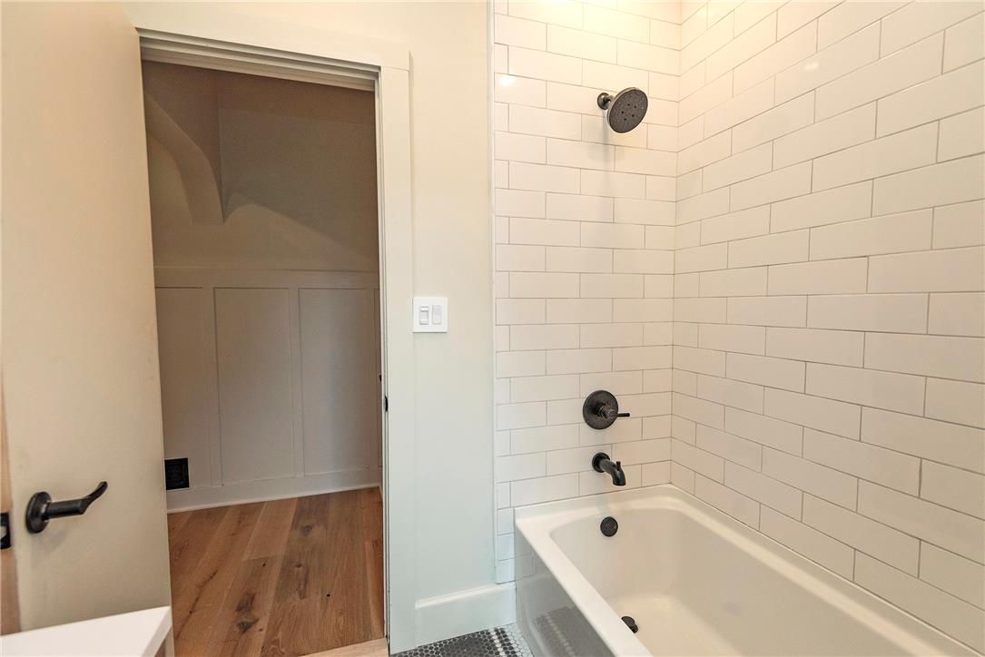100 Creek Road Bangor, PA 18013 - Photo 30 of 51 White subway tile adorns the bath surround, complementing the elegant dark bronze fixtures.