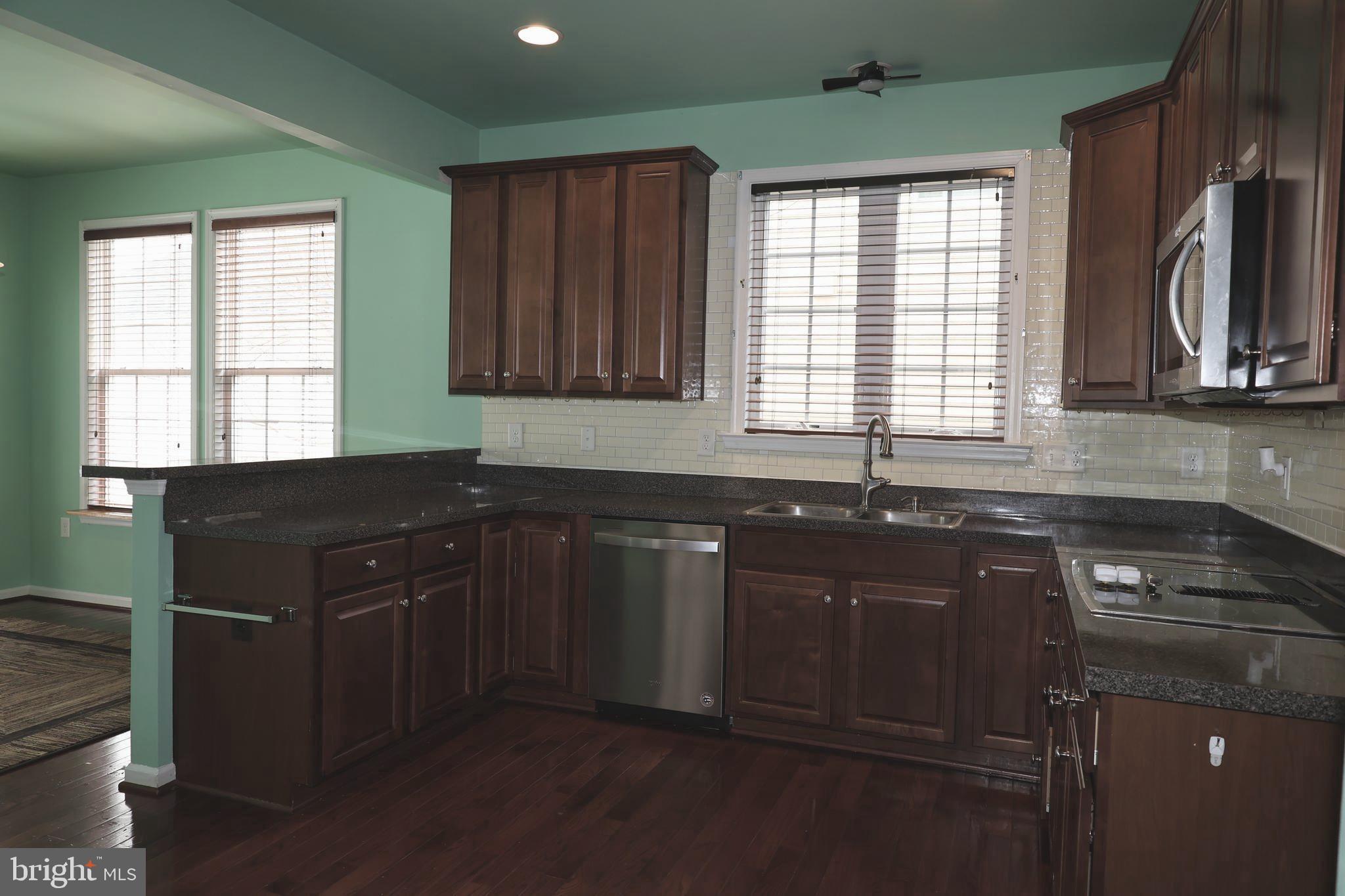 1224 North Fairfax Boulevard Ranson, WV 25438 - Photo 13 of 38 a kitchen with a sink stove and cabinets