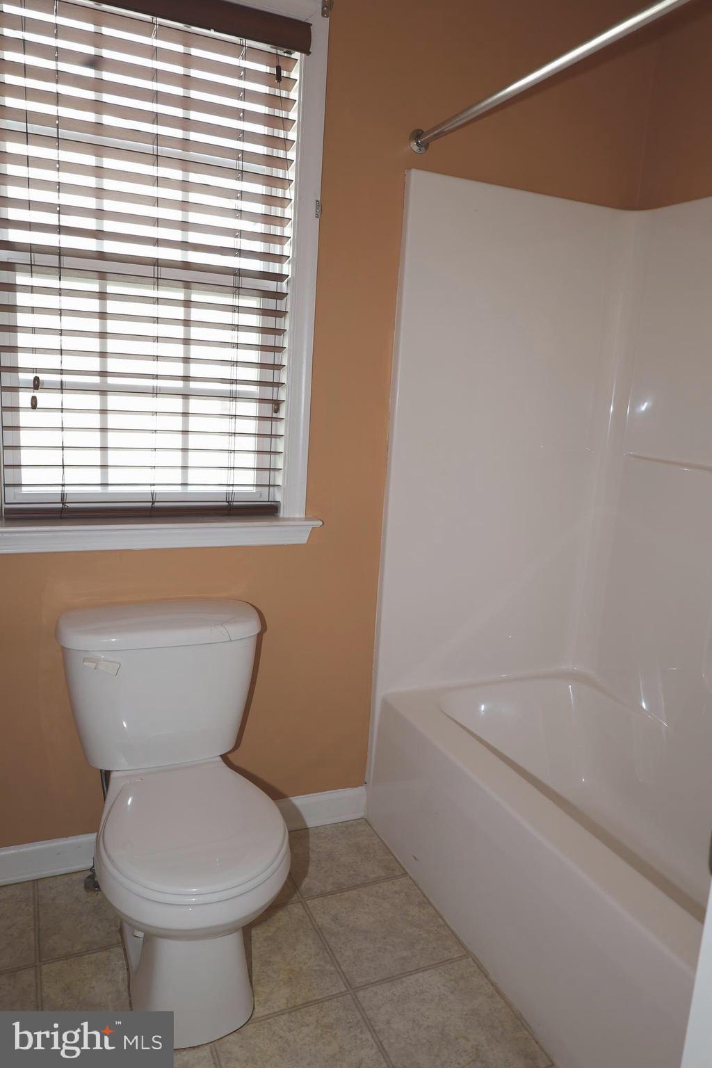 1224 North Fairfax Boulevard Ranson, WV 25438 - Photo 18 of 38 a bathroom with a toilet and a bathtub