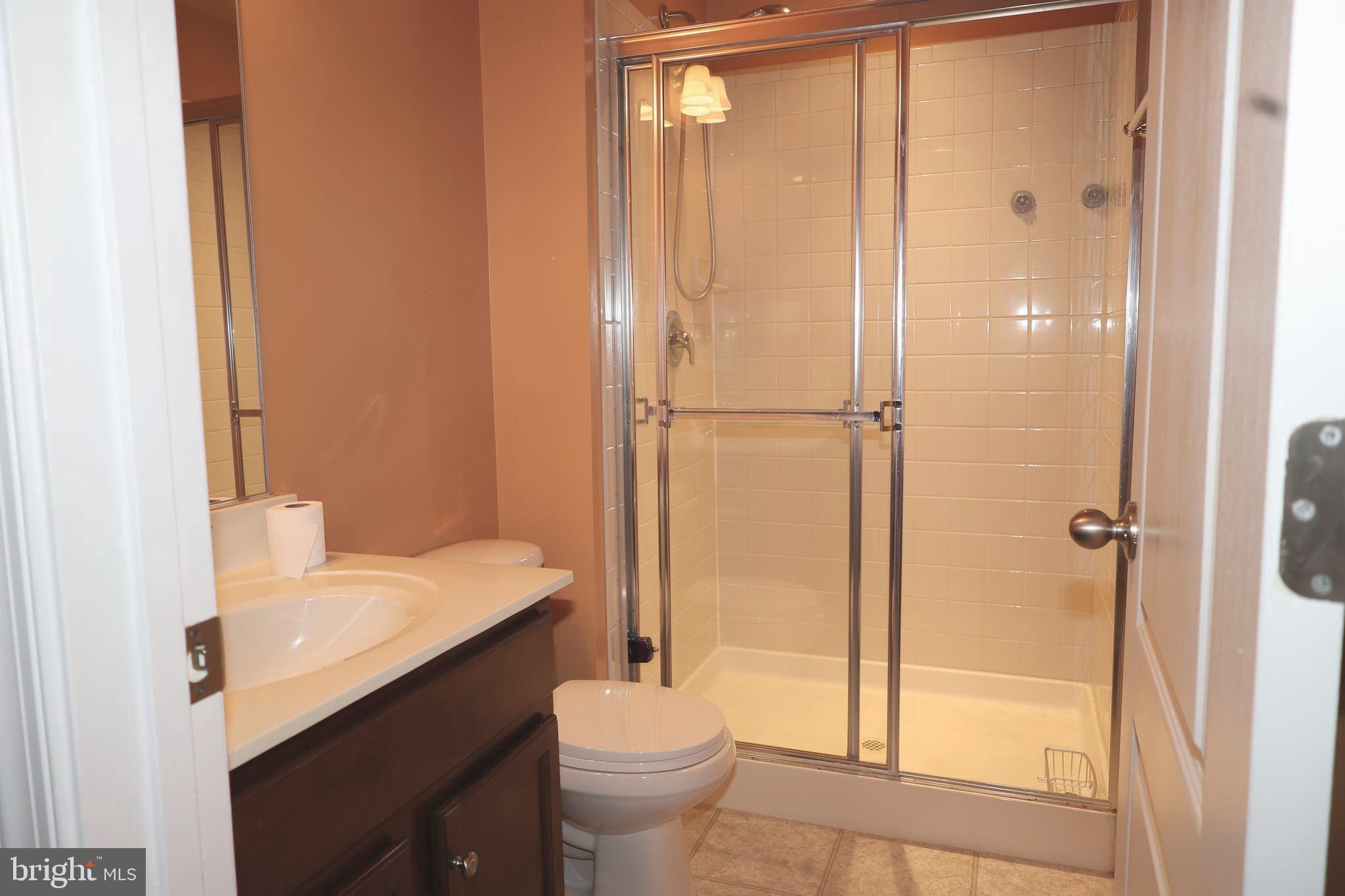 1224 North Fairfax Boulevard Ranson, WV 25438 - Photo 29 of 38 a bathroom with a sink a toilet and shower