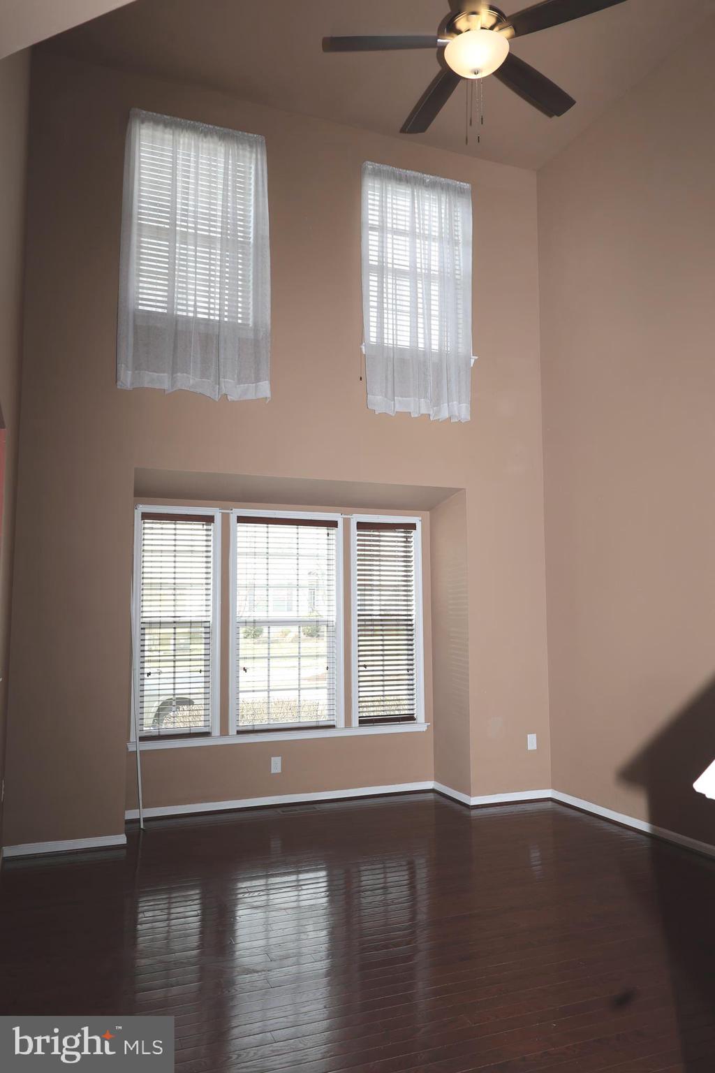 1224 North Fairfax Boulevard Ranson, WV 25438 - Photo 4 of 38 a view of an empty room with wooden floor and a window