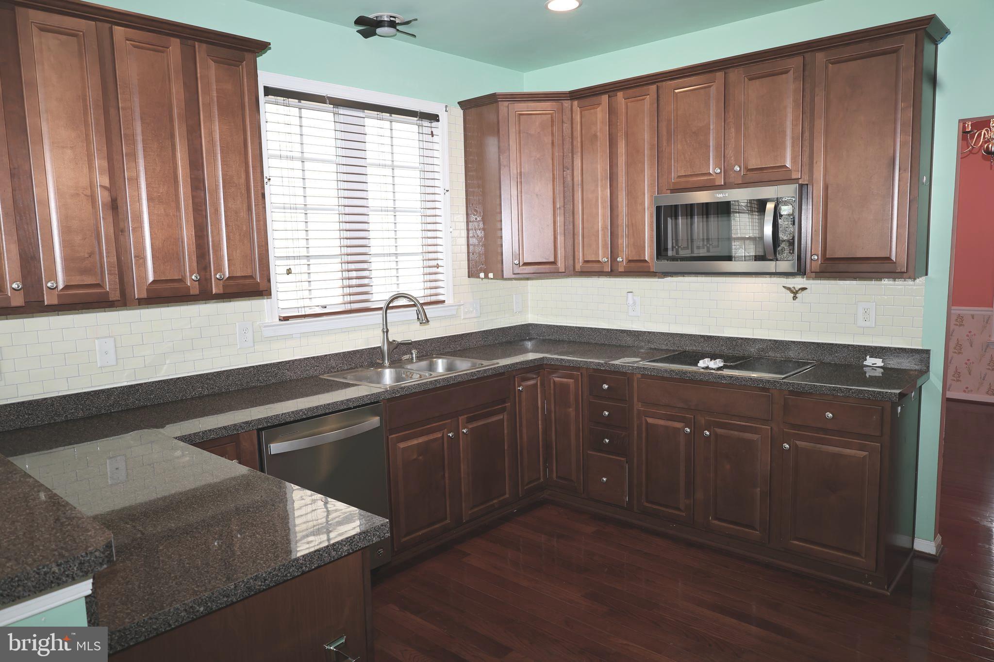 1224 North Fairfax Boulevard Ranson, WV 25438 - Photo 10 of 38 a kitchen with a sink cabinets and window