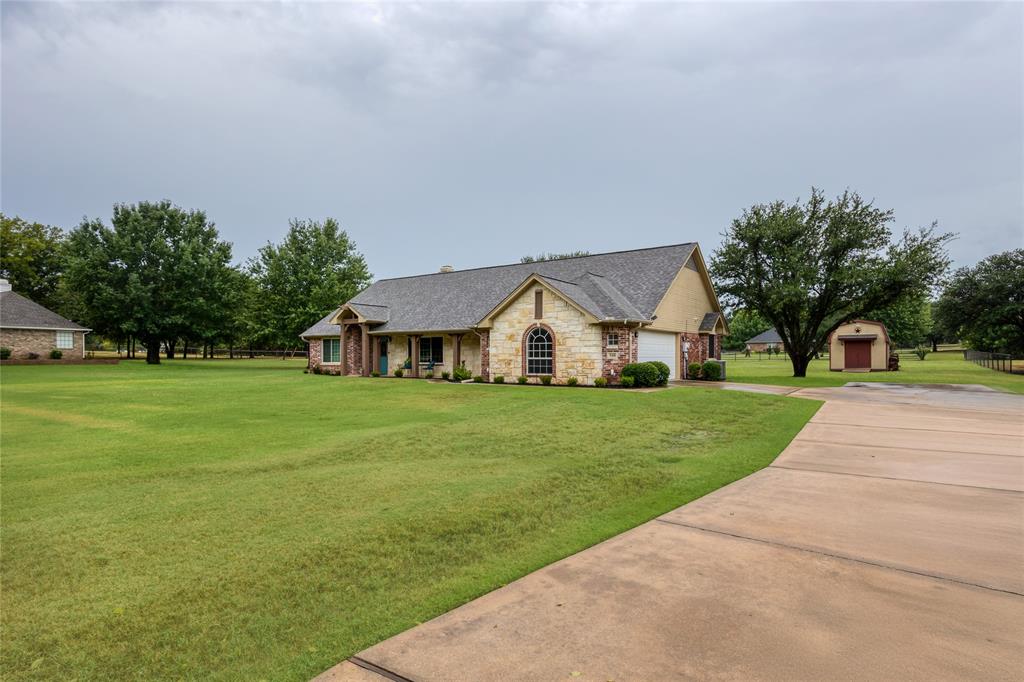 510 Highland Road Springtown, TX 76082 - Photo 12 of 40 a front view of a house with a yard