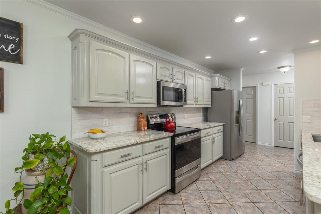 510 Highland Road Springtown, TX 76082 - Photo 14 of 40 a kitchen with a sink stove and refrigerator