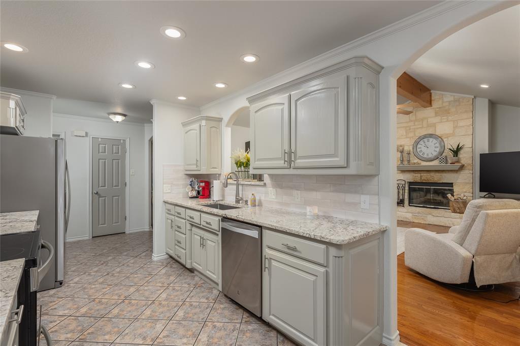 510 Highland Road Springtown, TX 76082 - Photo 15 of 40 a kitchen with a sink microwave and cabinets