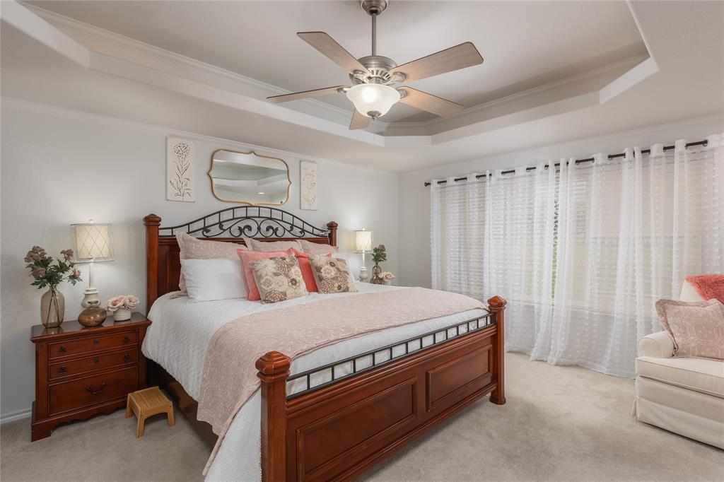 510 Highland Road Springtown, TX 76082 - Photo 18 of 40 a bedroom with a bed and a chandelier