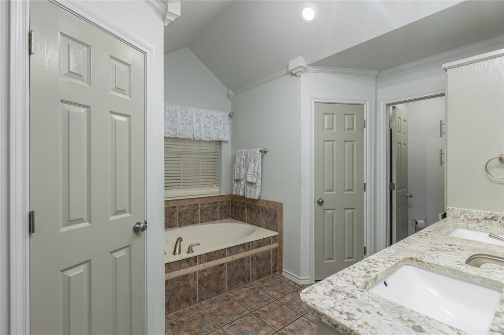 510 Highland Road Springtown, TX 76082 - Photo 20 of 40 a bathroom with a tub shower and sink