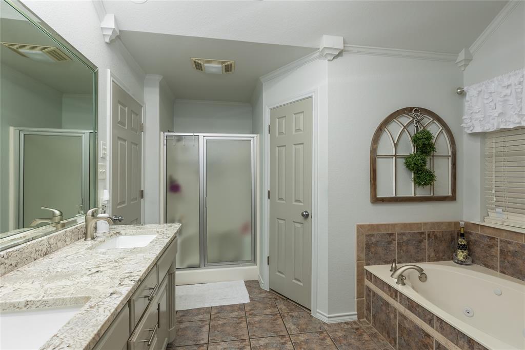 510 Highland Road Springtown, TX 76082 - Photo 21 of 40 a bathroom with a granite countertop tub sink shower and mirror