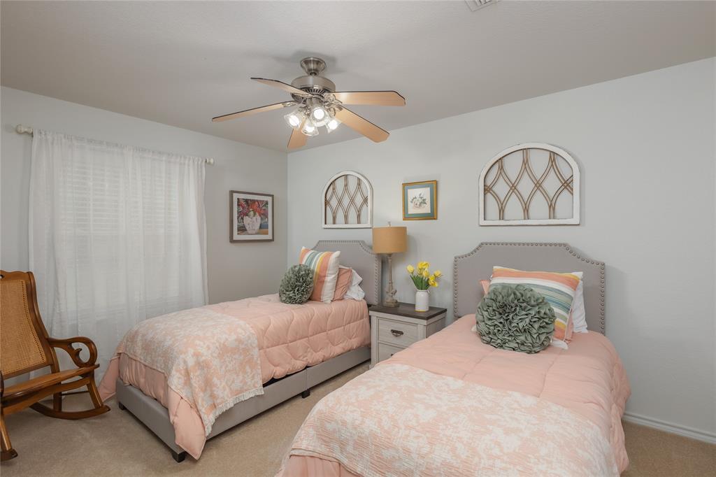 510 Highland Road Springtown, TX 76082 - Photo 22 of 40 a bedroom with two beds and painting on the wall