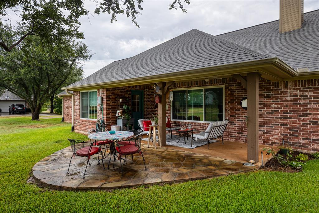 510 Highland Road Springtown, TX 76082 - Photo 29 of 40 a view of a house with backyard sitting area and garden