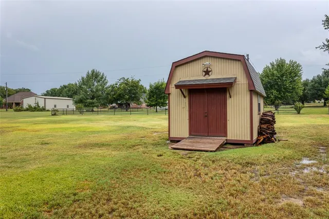 an aerial view of residential houses with yard
