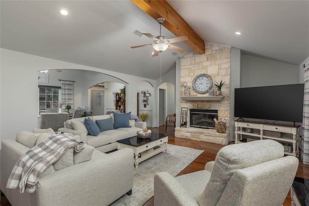 510 Highland Road Springtown, TX 76082 - Photo 3 of 40 a living room with furniture a flat screen tv and a fireplace