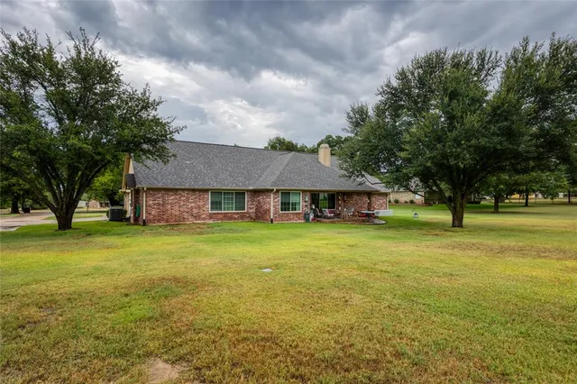 a view of a swimming pool with lawn chairs and plants