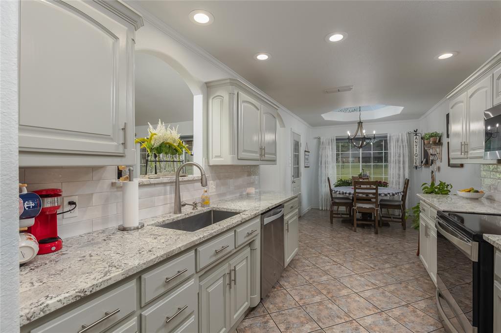 510 Highland Road Springtown, TX 76082 - Photo 5 of 40 a kitchen with sink cabinets and counter space