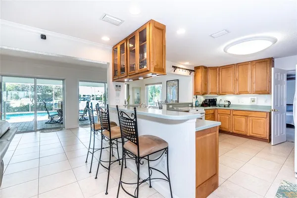 a kitchen with stainless steel appliances kitchen island granite countertop a stove a sink and cabinets