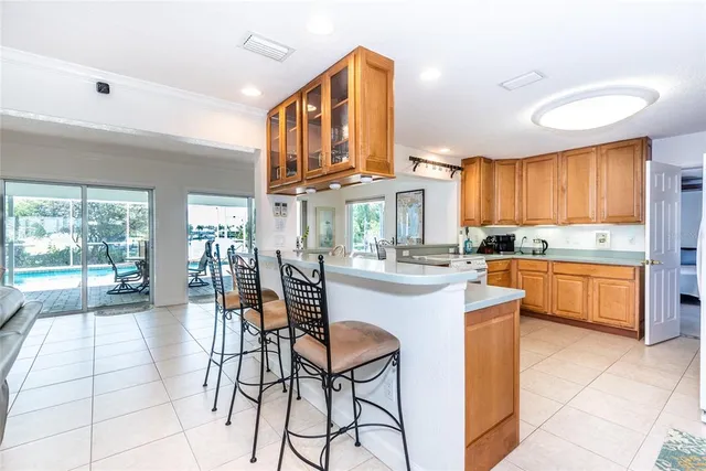 a kitchen with stainless steel appliances kitchen island granite countertop a stove a sink and cabinets