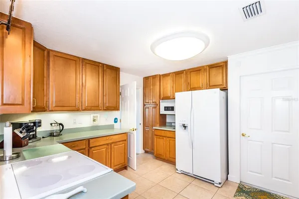 a kitchen with refrigerator and cabinets