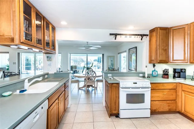 a kitchen with stainless steel appliances a stove a sink and a refrigerator