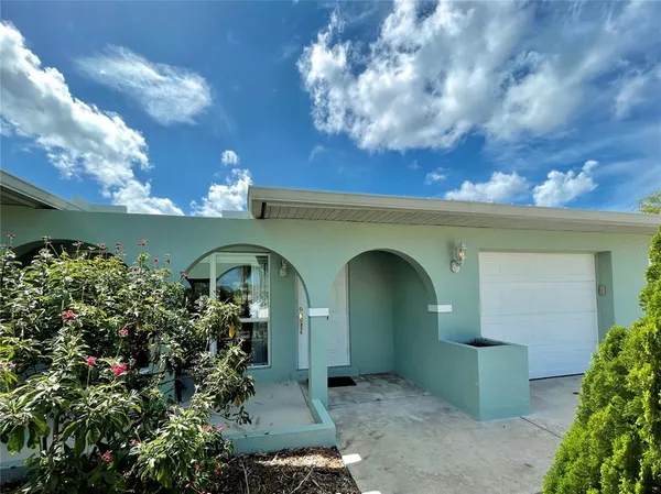 a front view of a house with plants