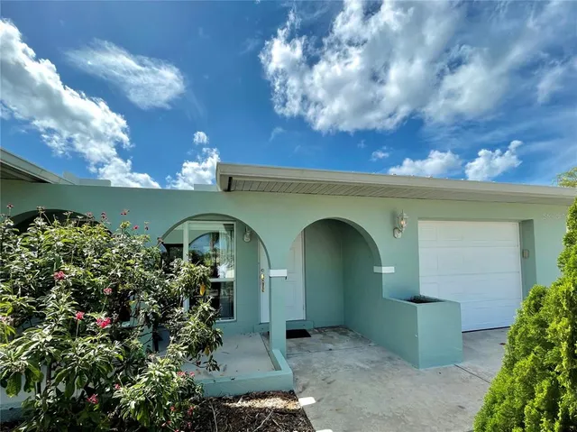 a front view of a house with plants