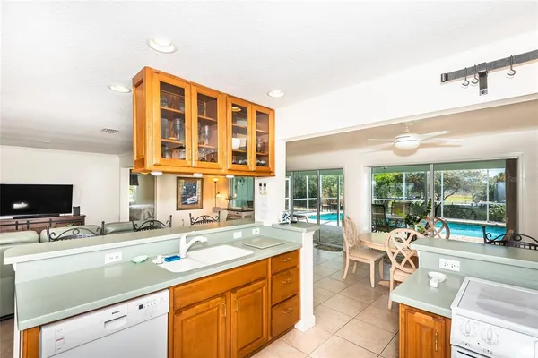 a kitchen with a sink and large windows