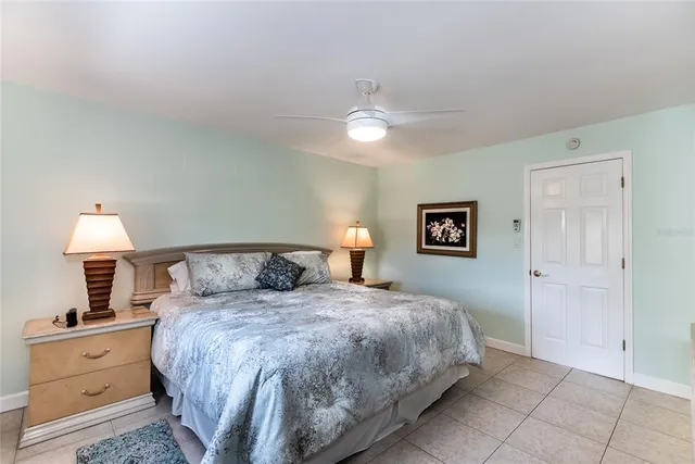 a bedroom with a bed and a lamp