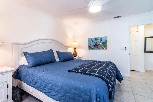 a bedroom with a bed and a painting on the wall