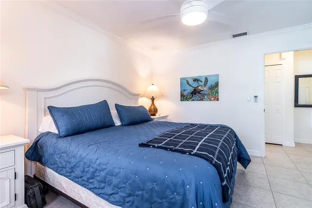 a bedroom with a bed and a painting on the wall