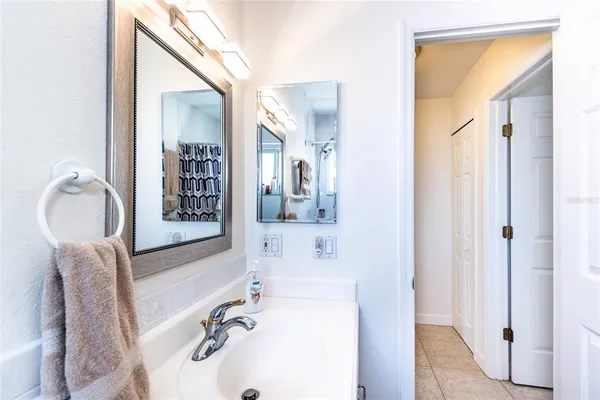 a bathroom with a tub sink and mirror