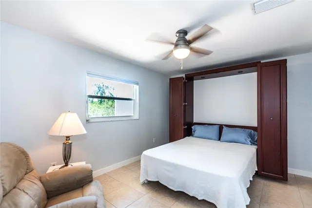 a bedroom with a bed and a lamp