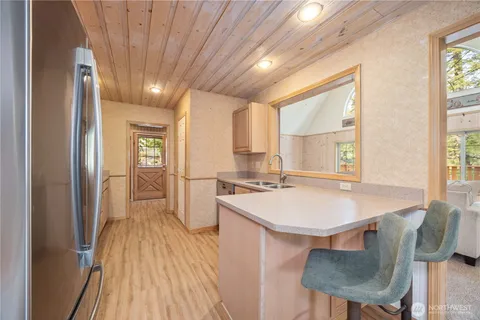 a kitchen with kitchen island a stove a sink and a refrigerator