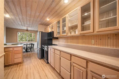 a kitchen with stainless steel appliances granite countertop a stove and cabinets