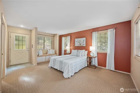 a spacious bedroom with a large bed and a window