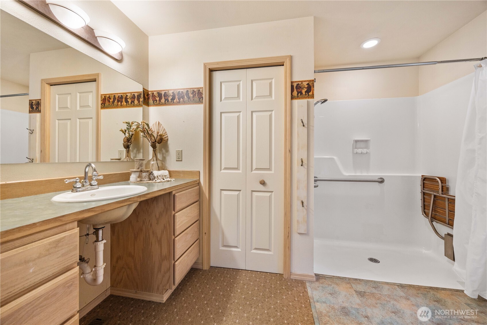 6545 Forest Ridge Drive Wenatchee, WA 98801 - Photo 17 of 40 a bathroom with a shower sink and mirror