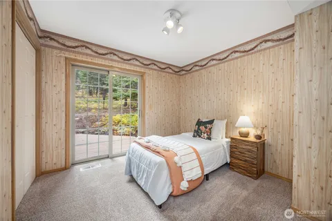 a bedroom with a bed a ceiling fan and a window